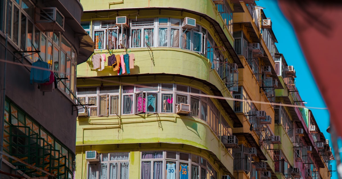 Clothes drying on a compact balcony rack at a city apartment